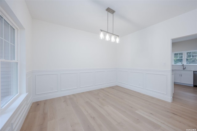 unfurnished room with sink and light wood-type flooring