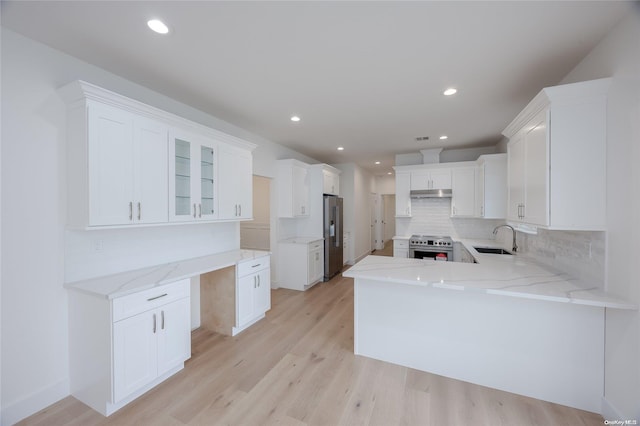 kitchen with white cabinetry, sink, stainless steel appliances, tasteful backsplash, and light hardwood / wood-style flooring