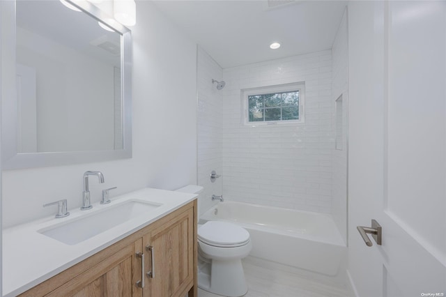 full bathroom featuring vanity, toilet, and tiled shower / bath