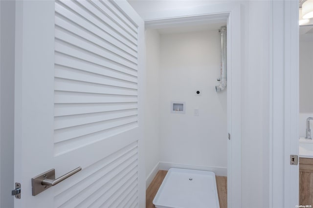 washroom featuring hookup for an electric dryer, washer hookup, and wood-type flooring