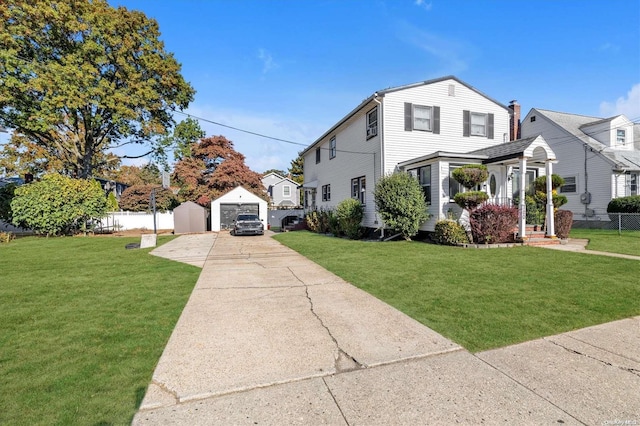 view of front facade featuring a front lawn, an outdoor structure, and a garage