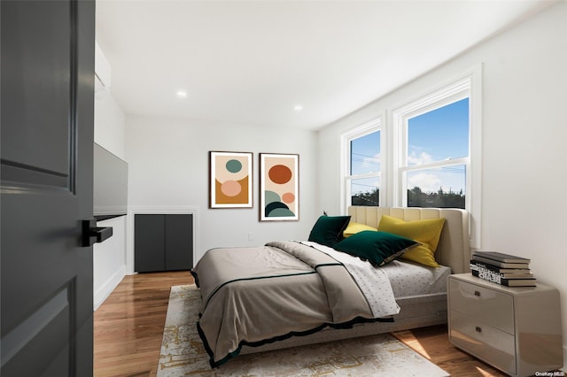 bedroom with hardwood / wood-style floors