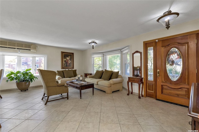 living room featuring a healthy amount of sunlight, light tile patterned floors, and a wall mounted AC