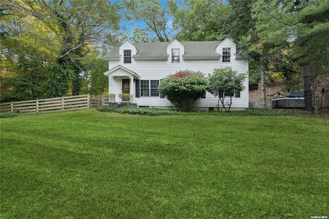 new england style home featuring a front yard