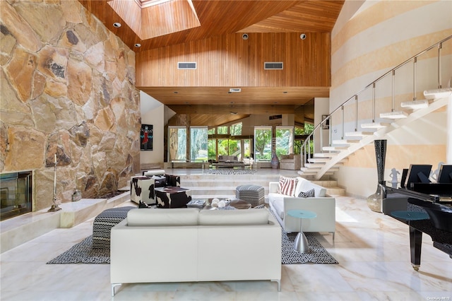 living room featuring wooden ceiling, high vaulted ceiling, and a skylight