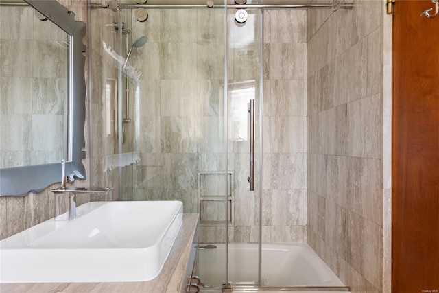 bathroom with shower / bath combination with glass door