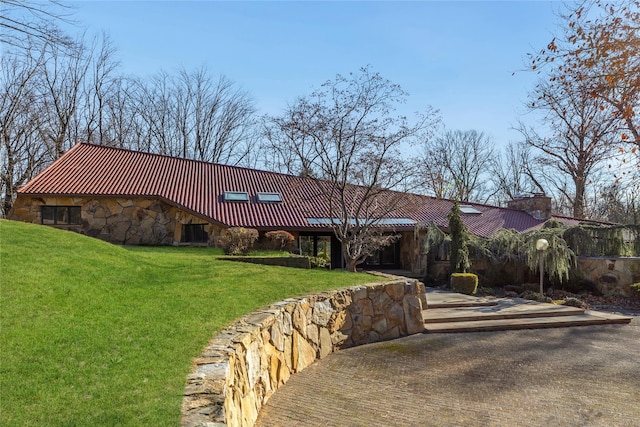 view of front of property with central AC and a front yard