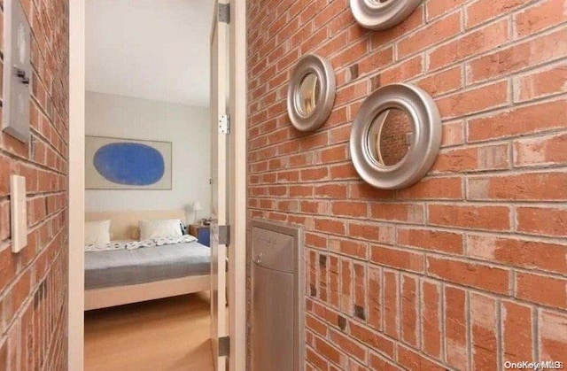 bathroom with brick wall