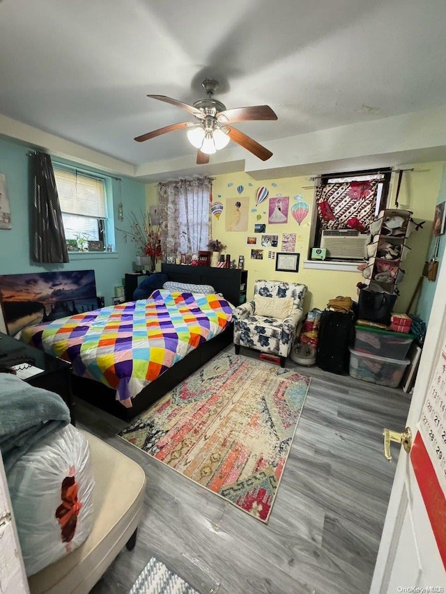 bedroom with ceiling fan and hardwood / wood-style flooring