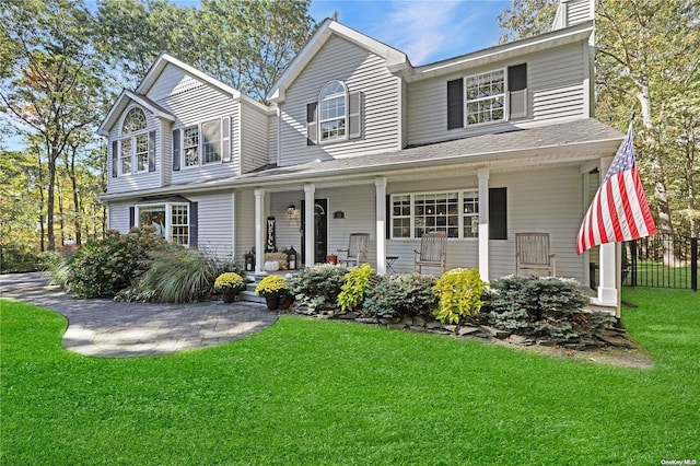 view of front of property with a porch and a front lawn