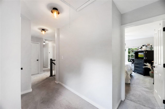 hallway featuring light colored carpet