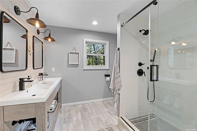 bathroom with hardwood / wood-style floors, vanity, backsplash, and walk in shower