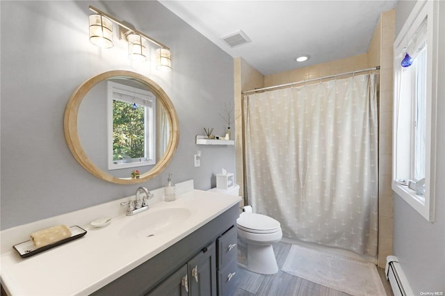 bathroom with vanity, toilet, baseboard heating, and walk in shower