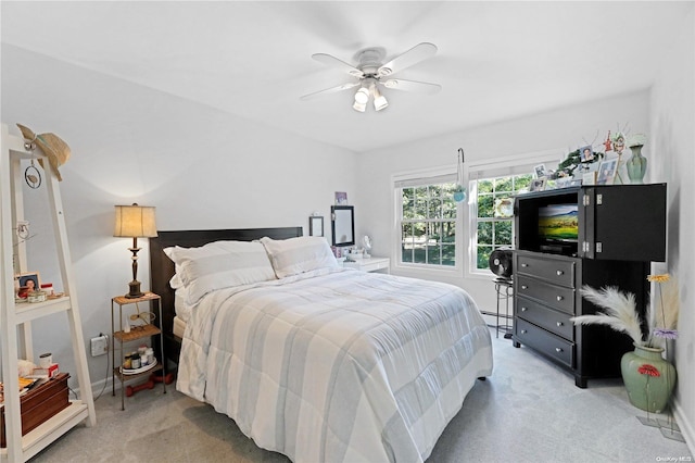 bedroom with ceiling fan, light colored carpet, and a baseboard radiator