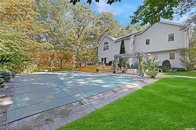 view of pool featuring a yard, a pergola, and a deck