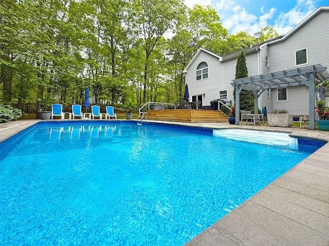 18 Diane Dr, Manorville, NY 11949 - swimming pool featuring a pergola, a deck, and view of wooded area