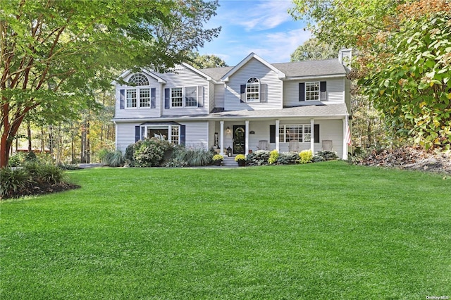 18 Diane Dr, Manorville, NY 11949 - traditional-style house featuring a front yard, a porch, and a chimney