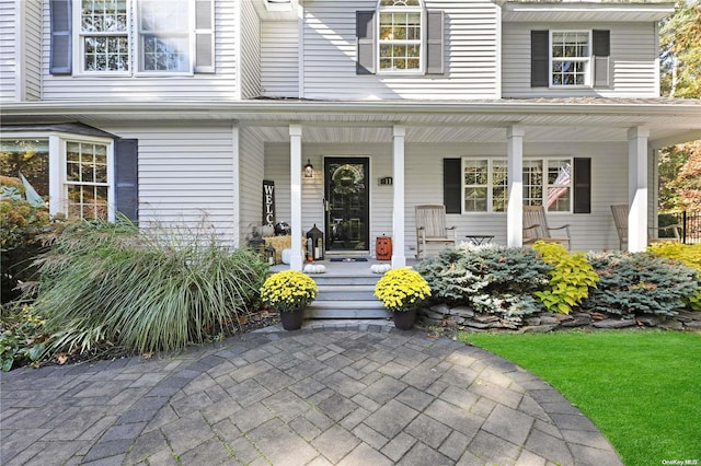 18 Diane Dr, Manorville, NY 11949 - doorway to property featuring a porch