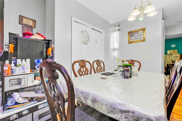 dining area with a chandelier and light hardwood / wood-style floors