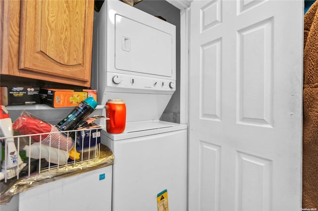 laundry area with stacked washer / drying machine