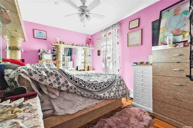 bedroom featuring hardwood / wood-style flooring and ceiling fan