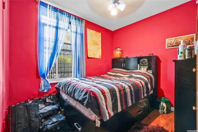 bedroom with ceiling fan and wood-type flooring