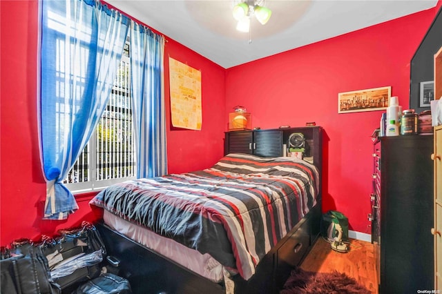 bedroom with ceiling fan and wood-type flooring