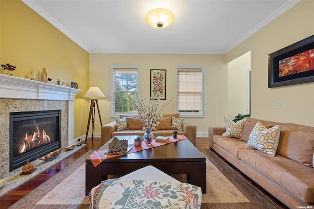 living room featuring wood-type flooring, crown molding, and a high end fireplace