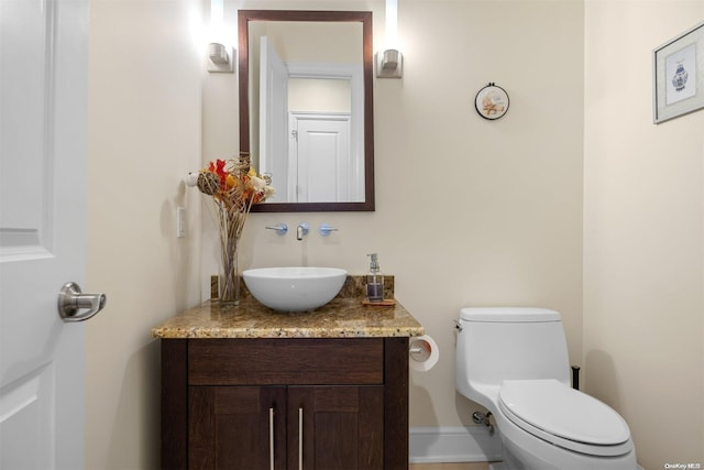 bathroom featuring vanity and toilet