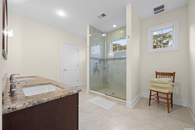 bathroom with vanity, tile patterned flooring, and walk in shower