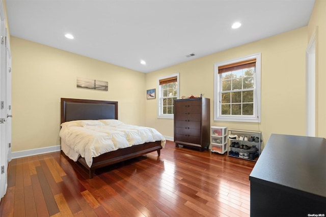 bedroom with dark hardwood / wood-style flooring