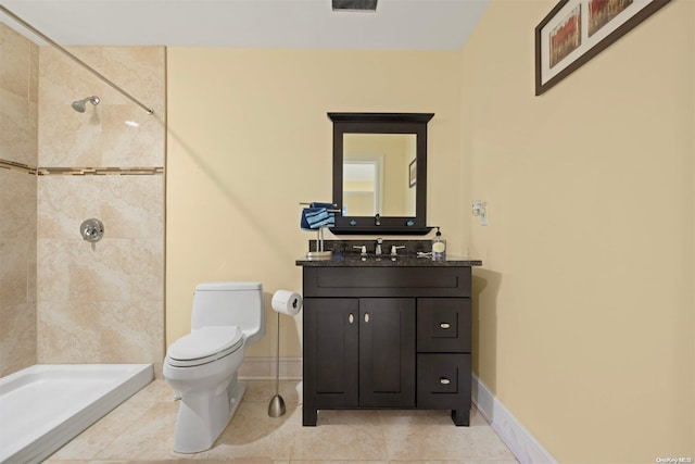 bathroom featuring vanity, toilet, and a tile shower