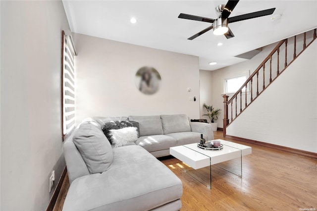 living room with ceiling fan and light hardwood / wood-style floors