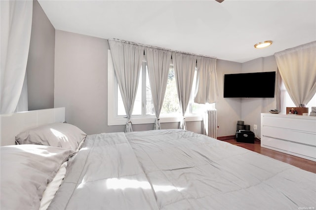 bedroom featuring wood-type flooring and radiator