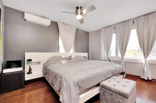 bedroom featuring a wall unit AC, ceiling fan, and dark hardwood / wood-style floors