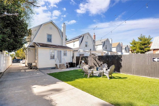 rear view of house with a yard