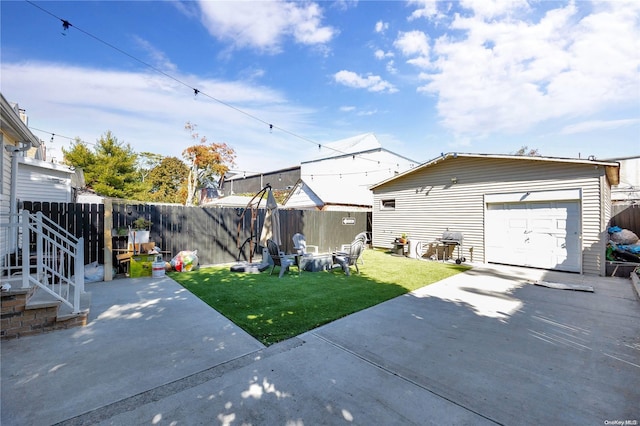 exterior space featuring a yard, an outbuilding, a patio, and a garage