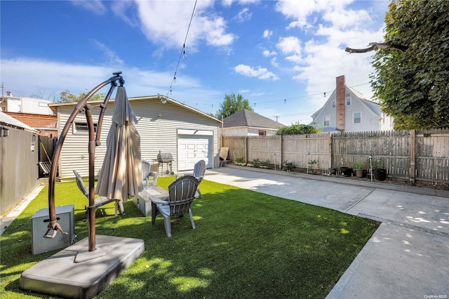 view of yard with a garage and an outdoor structure