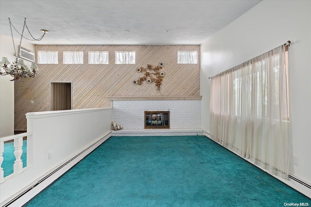 unfurnished living room featuring a fireplace, a baseboard radiator, dark carpet, and wood walls