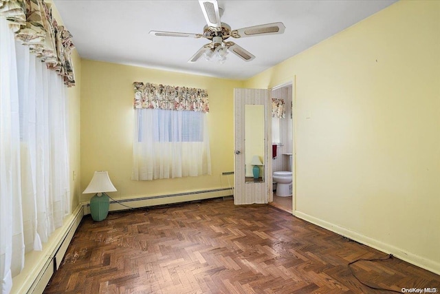 empty room featuring dark parquet flooring, ceiling fan, and a baseboard heating unit