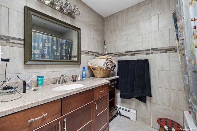 bathroom featuring a shower with shower curtain, vanity, a baseboard radiator, tile walls, and tile patterned flooring