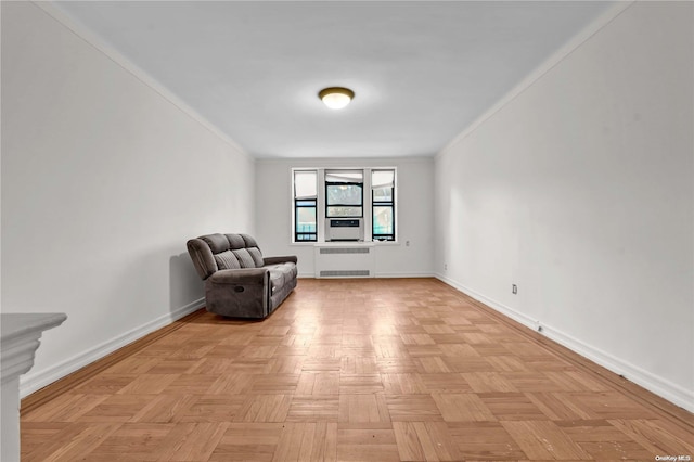 unfurnished room with light parquet flooring, radiator, and crown molding