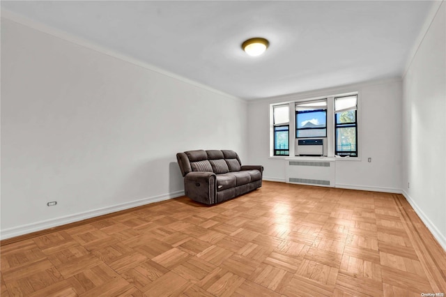 sitting room featuring radiator heating unit, ornamental molding, and light parquet floors