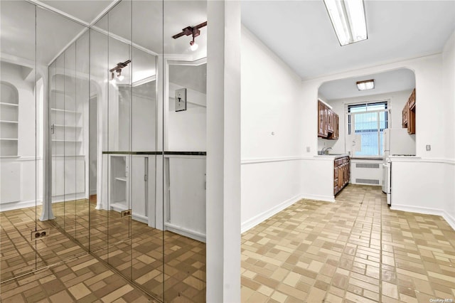 bathroom featuring radiator and sink