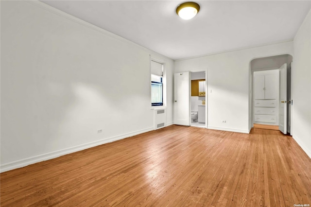 empty room with light hardwood / wood-style flooring