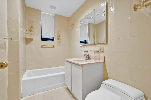 full bathroom with tiled shower / bath, tile walls, vanity, toilet, and tile patterned floors