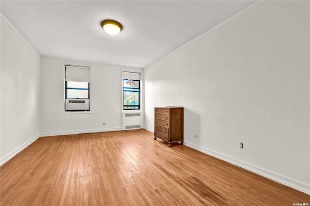 empty room with radiator and light hardwood / wood-style floors