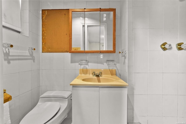 bathroom with tile walls, vanity, tasteful backsplash, and toilet