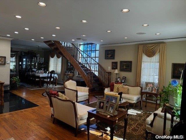 living room with hardwood / wood-style flooring and crown molding