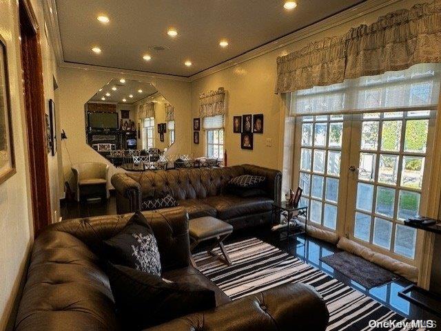 living room with crown molding and plenty of natural light